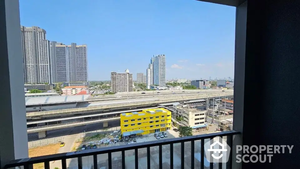 Stunning urban view from high-rise balcony overlooking cityscape and railway