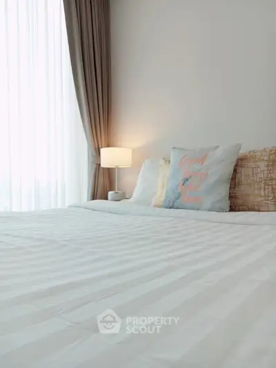 Cozy bedroom with elegant decor and soft lighting, perfect for relaxation and comfort.