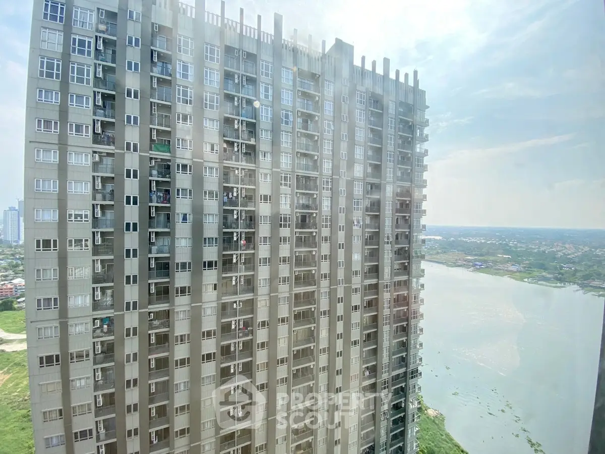 High-rise apartment building with scenic river view in urban setting