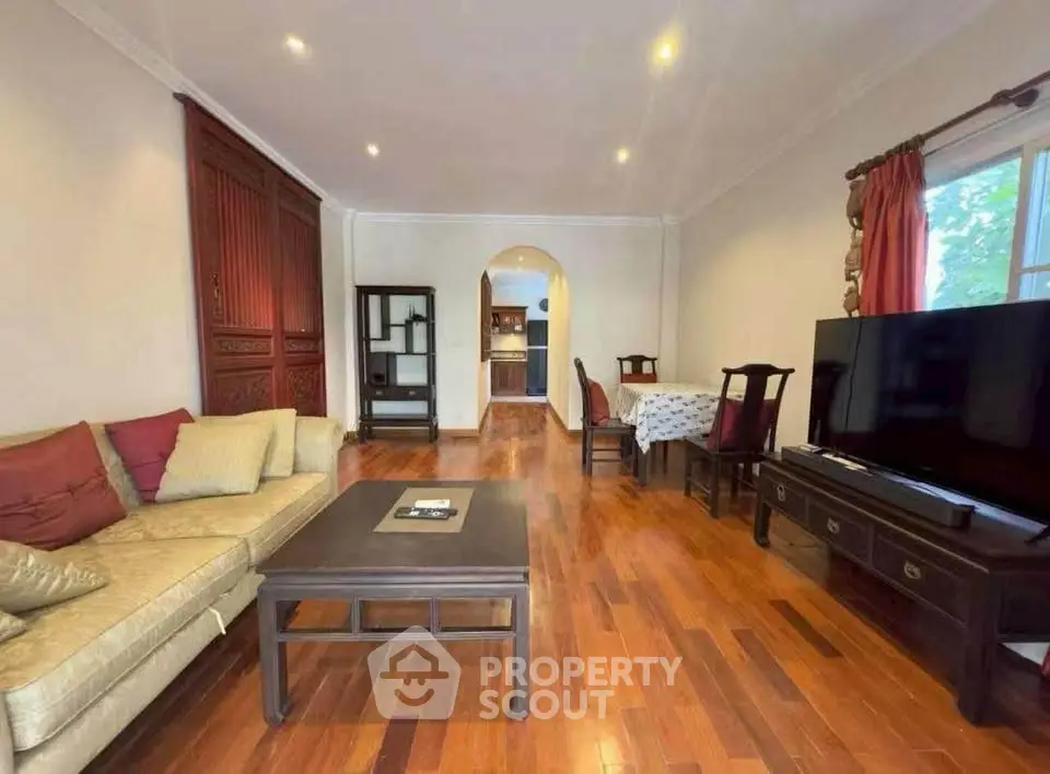 Spacious living room with elegant wooden flooring and modern furniture