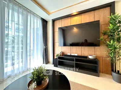Modern living room with large TV, stylish decor, and floor-to-ceiling windows.