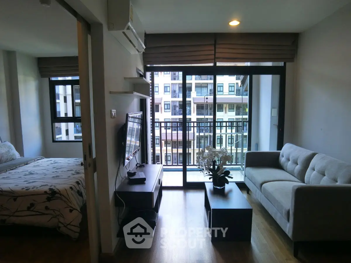 Modern apartment living room with balcony view and stylish furnishings