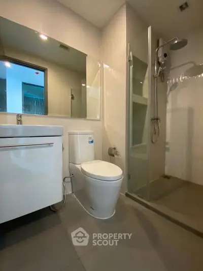 Modern bathroom with sleek fixtures and glass shower enclosure