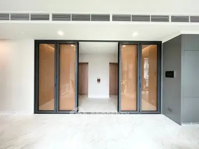 Spacious modern living room with sliding glass doors and marble flooring