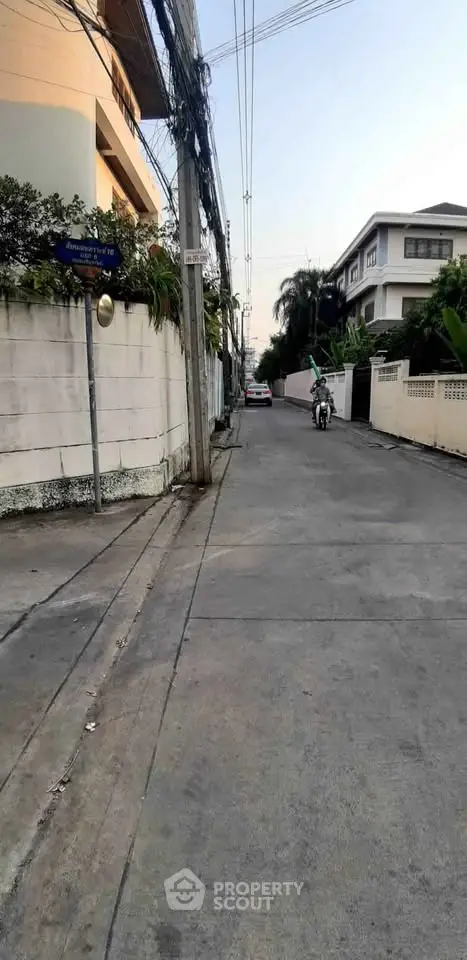 Charming residential street with modern houses and lush greenery, perfect for serene urban living.