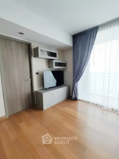 Modern living room with wooden flooring and stylish TV unit