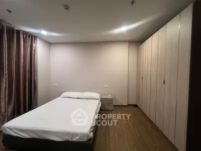 Spacious bedroom with modern design and ample wardrobe space