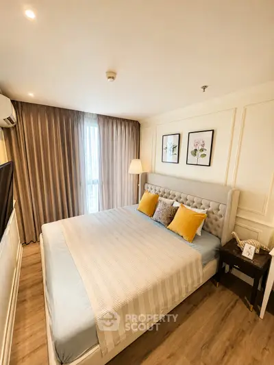Elegant bedroom with cozy decor and natural light, featuring a plush bed and stylish accents.