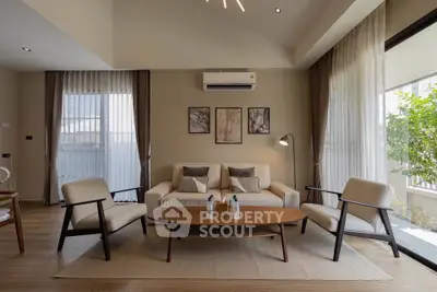 Modern living room with stylish furniture and large windows for natural light.