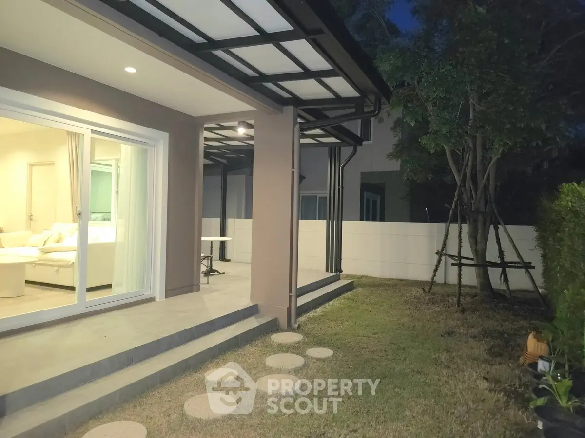 Charming backyard view with modern patio and lush garden, perfect for outdoor relaxation and entertaining.