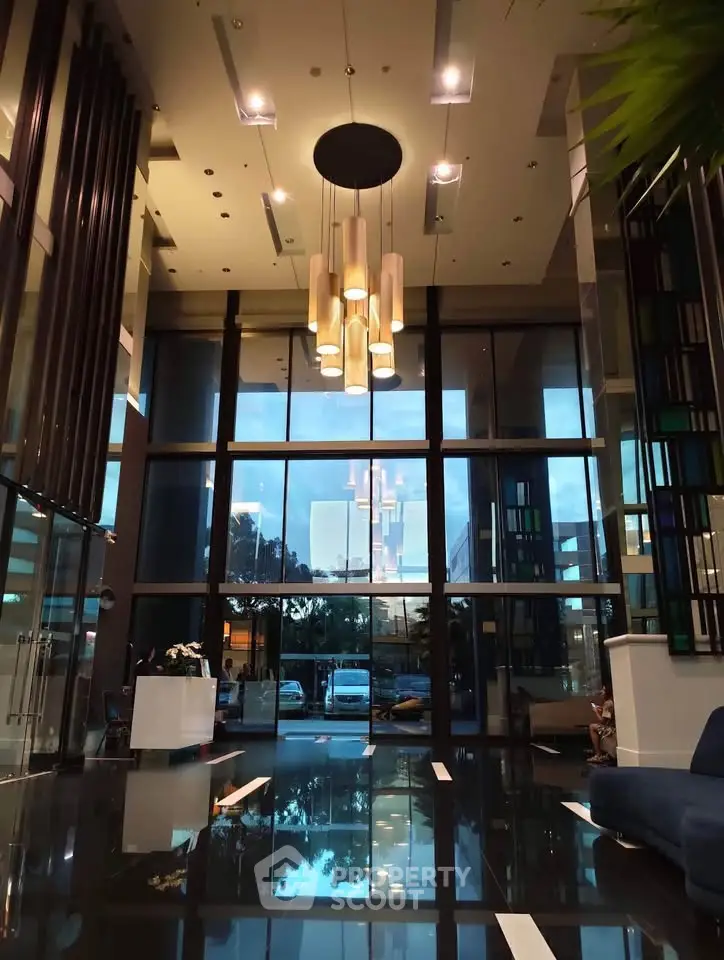 Luxurious modern building entrance with high ceilings and elegant lighting