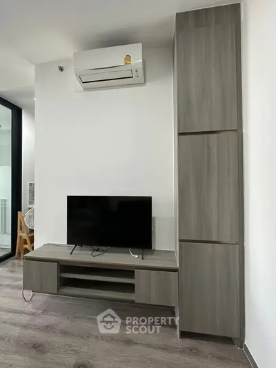 Modern living room with sleek TV stand and air conditioning unit