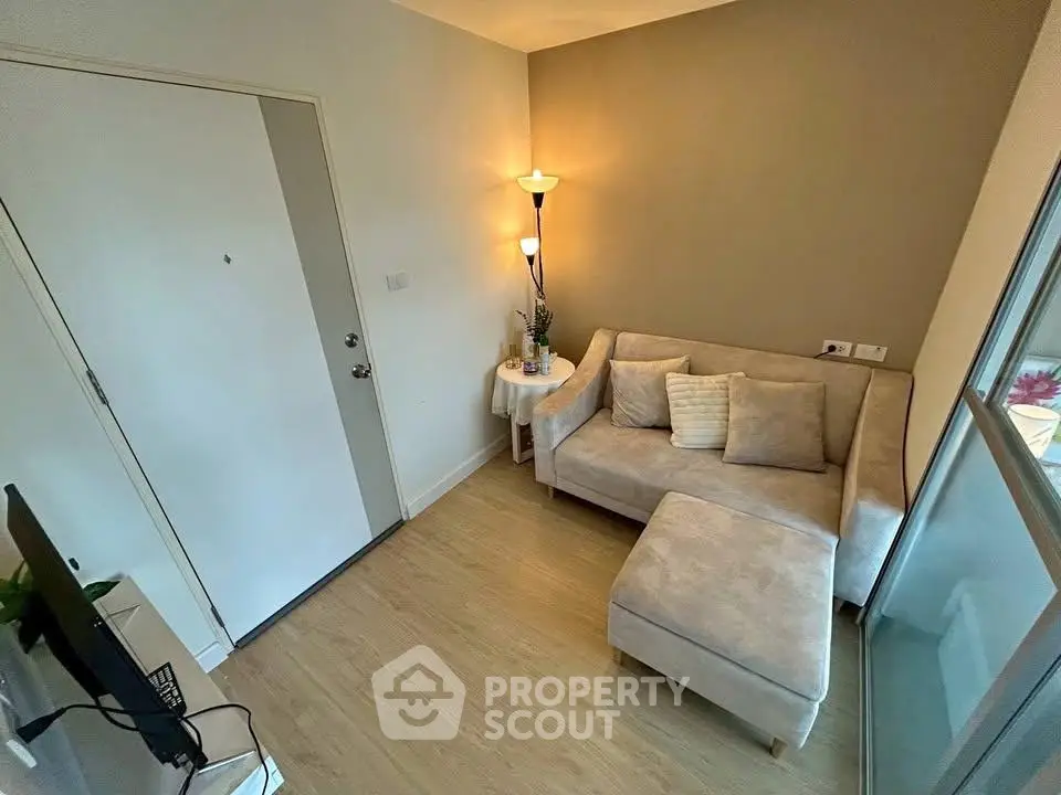 Cozy living room with modern beige sofa and stylish floor lamp, perfect for relaxation.