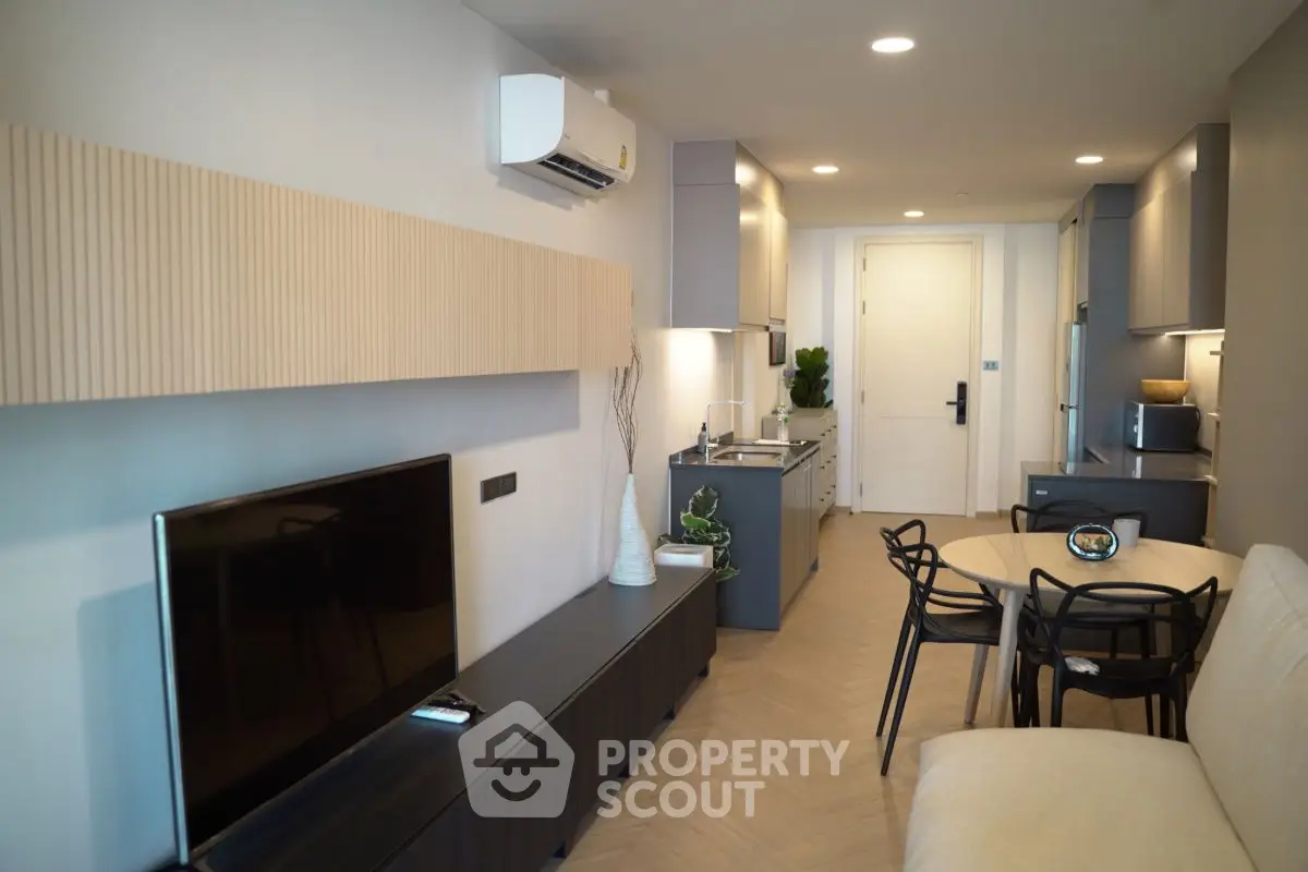 Modern living room with sleek furniture and open kitchen layout