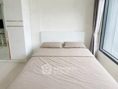 Modern bedroom with large window and minimalist design, featuring a cozy double bed and sleek wardrobe.
