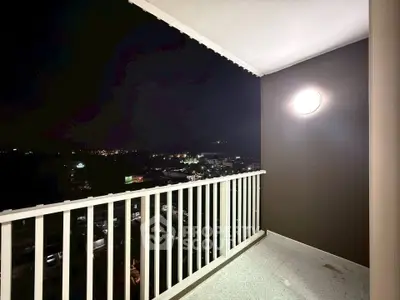 Spacious balcony with stunning night city view, perfect for relaxation and enjoying the skyline.