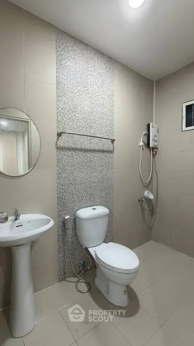 Modern bathroom with sleek fixtures and tiled walls, featuring a shower and toilet.