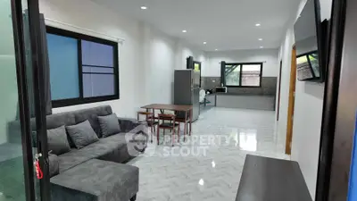 Spacious open-plan living room with modern kitchen and stylish furnishings