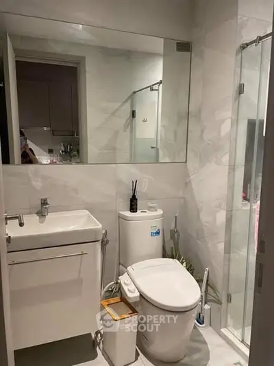 Modern bathroom with sleek fixtures and glass shower enclosure