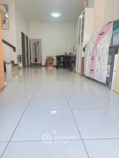 Spacious interior with glossy tiled flooring and modern decor, ideal for family gatherings.