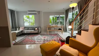 Spacious living room with modern decor and large windows offering natural light.