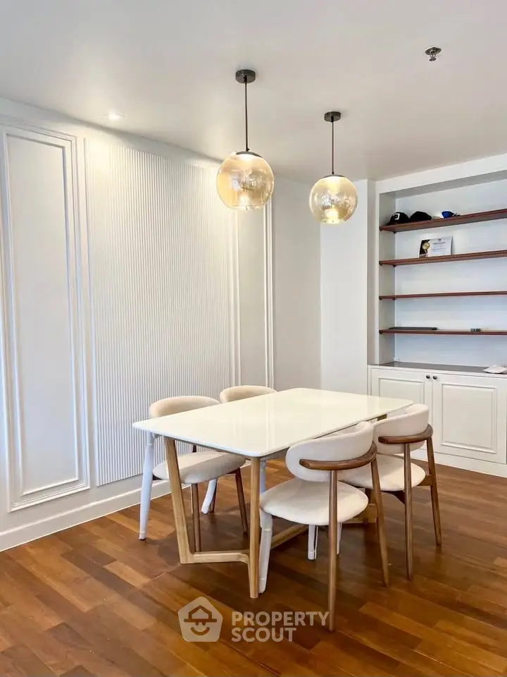 Elegant dining area with modern lighting and wooden flooring