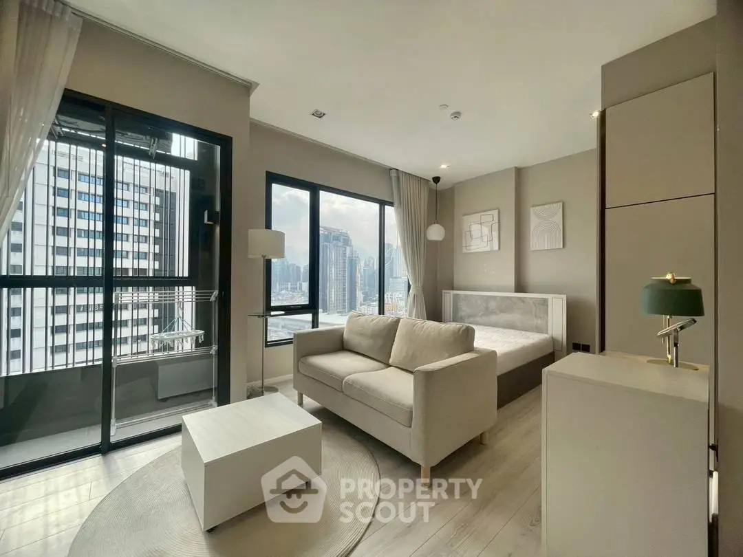 Modern studio apartment with city view, featuring cozy living area and stylish decor.