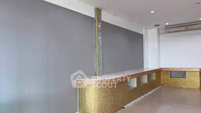 Modern commercial interior with sleek gold accents and minimalist design, perfect for upscale business settings.