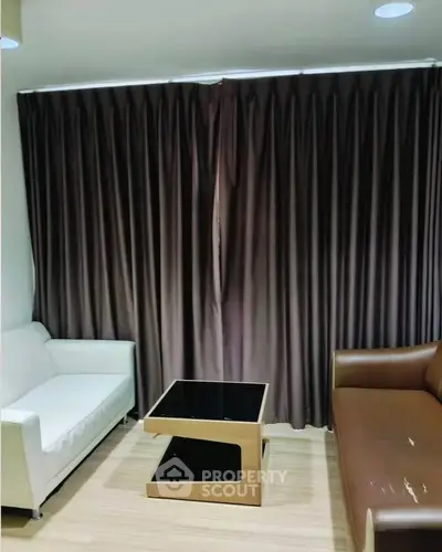 Cozy living room with modern furniture and elegant curtains, perfect for relaxation.
