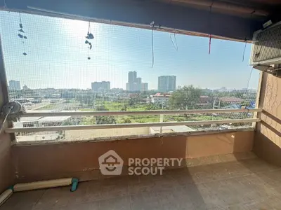 Spacious balcony with city skyline view, perfect for relaxing and enjoying the urban landscape.