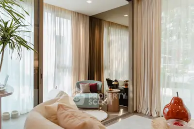 Luxurious living room with elegant decor and large windows offering natural light.