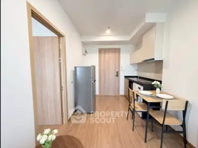 Modern apartment kitchen with sleek design and compact dining area