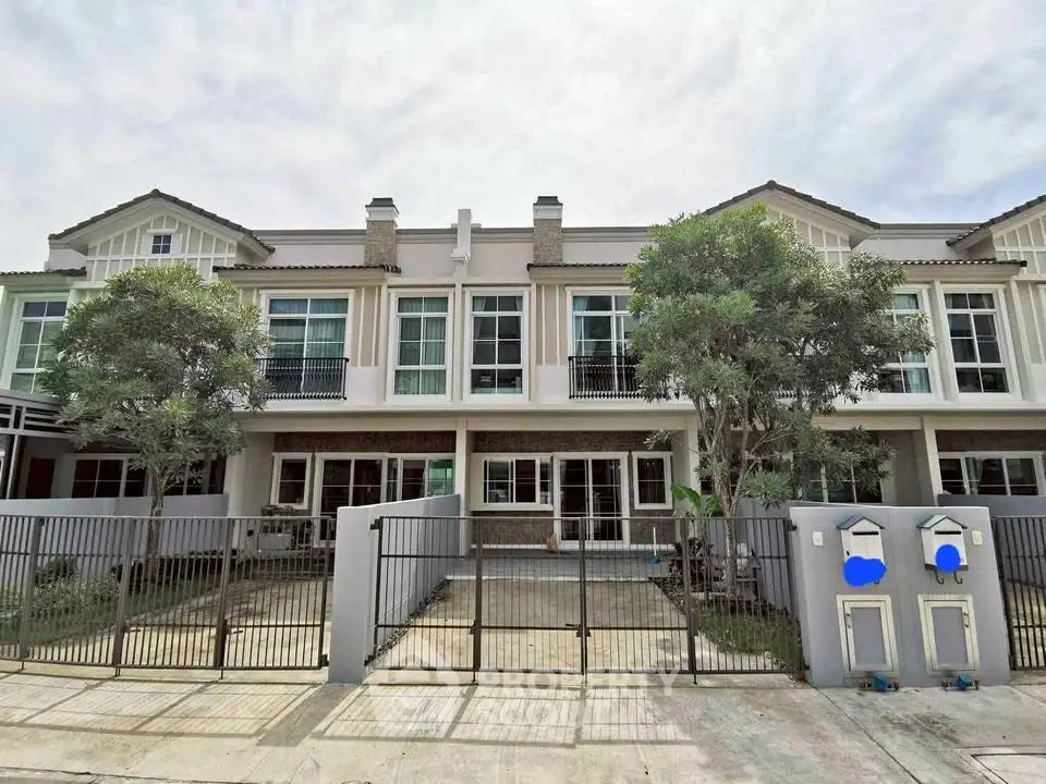 Charming townhouse with modern facade and gated entrance, perfect for family living.