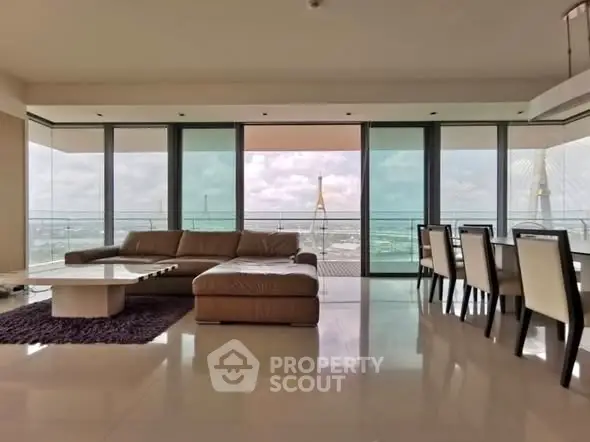 Luxurious living room with panoramic city view and elegant furnishings.