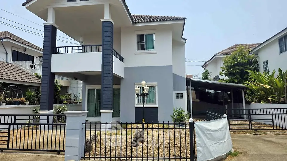 Charming two-story house with modern facade and spacious driveway in a serene neighborhood.