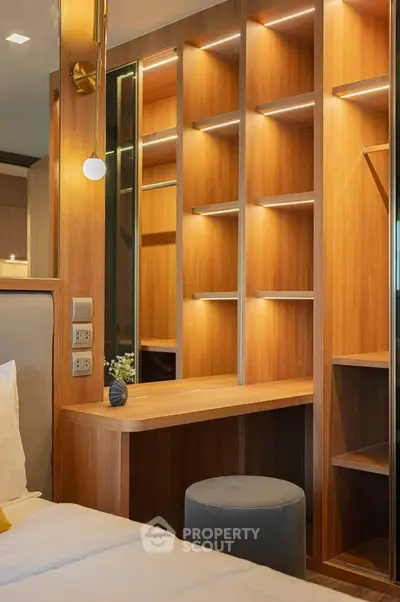 Luxurious bedroom with elegant wooden shelving and modern lighting, perfect for stylish living.