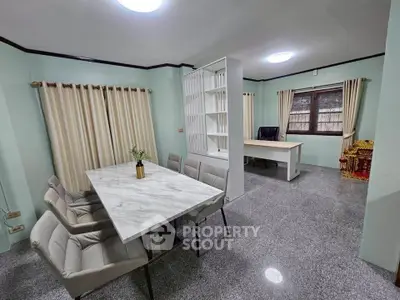 Spacious study room with modern furniture and ample natural light, perfect for productivity and comfort.