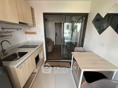 Modern kitchen with sleek cabinetry and dining area in a stylish apartment