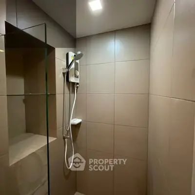 Modern bathroom with sleek shower design and neutral tiles