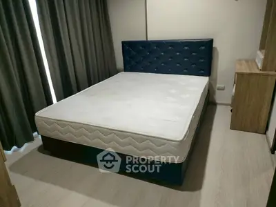 Spacious bedroom with modern bed and elegant decor, perfect for relaxation and comfort.