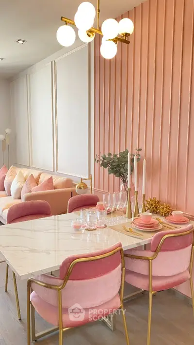 Elegant dining area with pink accents and modern lighting in a stylish home interior.