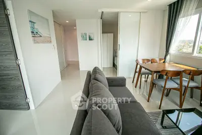 Modern living room with sleek furniture and natural light in a stylish apartment.