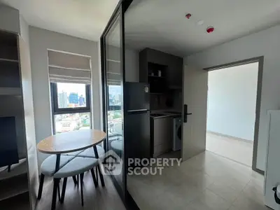 Modern apartment with city view, featuring a compact kitchen and dining area with sleek design.