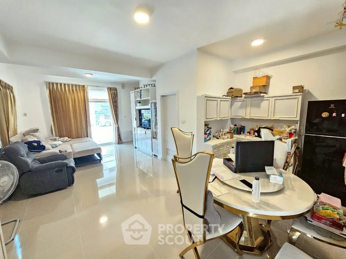 Spacious living room with modern decor and open kitchen layout