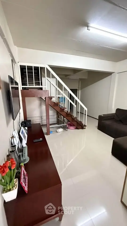 Spacious living room with modern staircase and sleek flooring