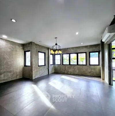 Spacious modern living room with large windows and stylish lighting