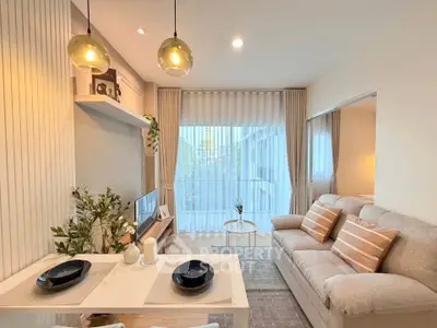 Modern living room with cozy sofa, elegant decor, and large window for natural light.