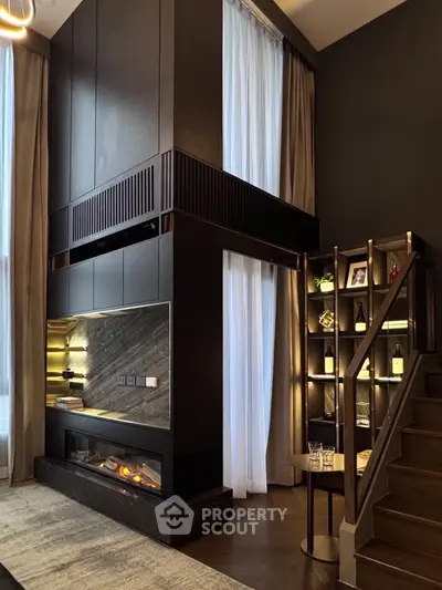 Luxurious modern living room with high ceilings, elegant fireplace, and stylish shelving unit.