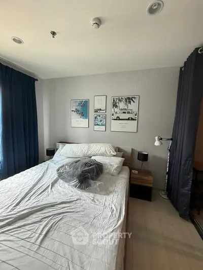 Modern bedroom with stylish decor and natural light, featuring a comfortable bed and elegant wall art.