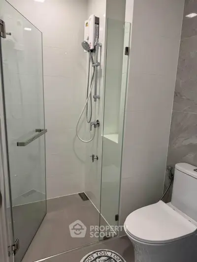 Modern bathroom with glass shower enclosure and sleek fixtures